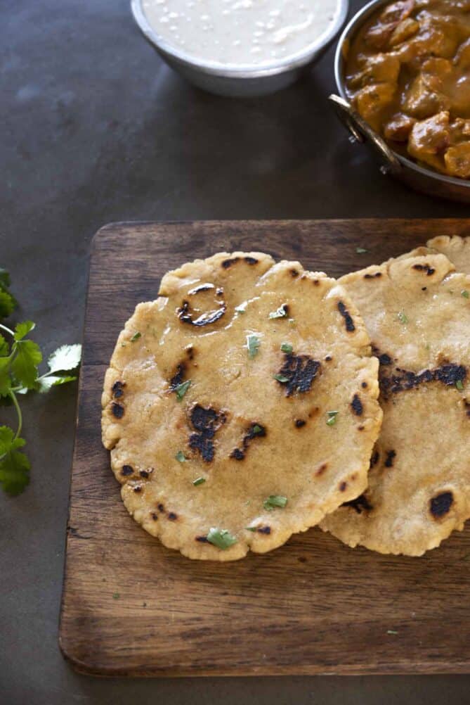 Rounds of gluten free naan bread on a board