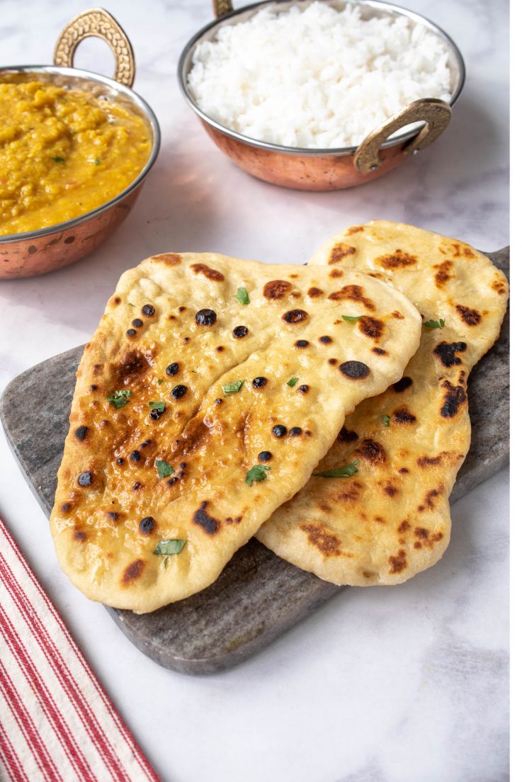 2 pieces of naan bread on a serving platter