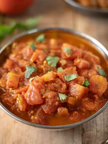 Indian tomato chutney in a bowl garnished with cilantro
