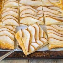 Pear tart on a baking sheet cut into squares