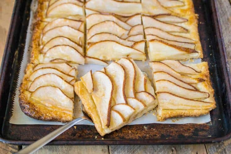Pear tart on a baking sheet cut into squares