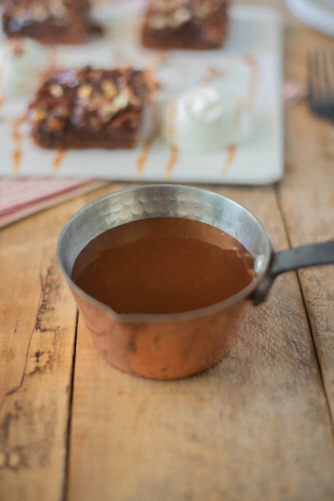 A small copper pan filled with caramel sauce