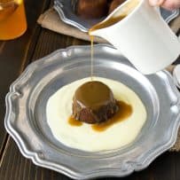 Pouring toffee sauce over sticky toffee pudding