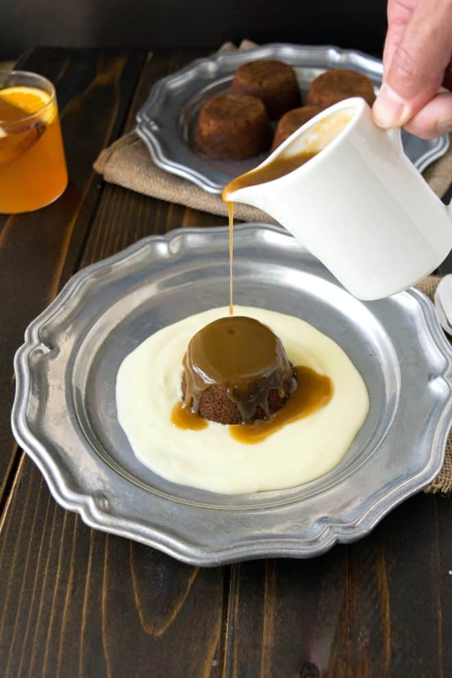 Pouring toffee sauce over sticky toffee pudding