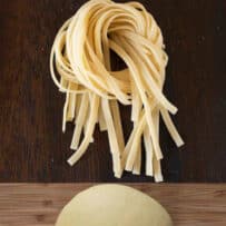 A ball of eggless pasta dough and tagliatelle