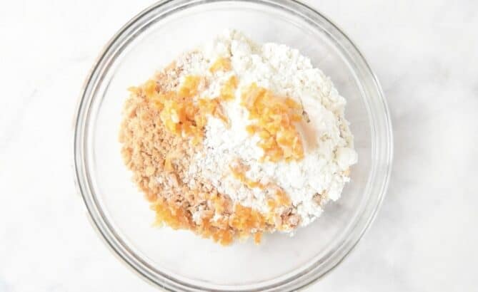 Ground almonds, flour and orange peel in a bowl
