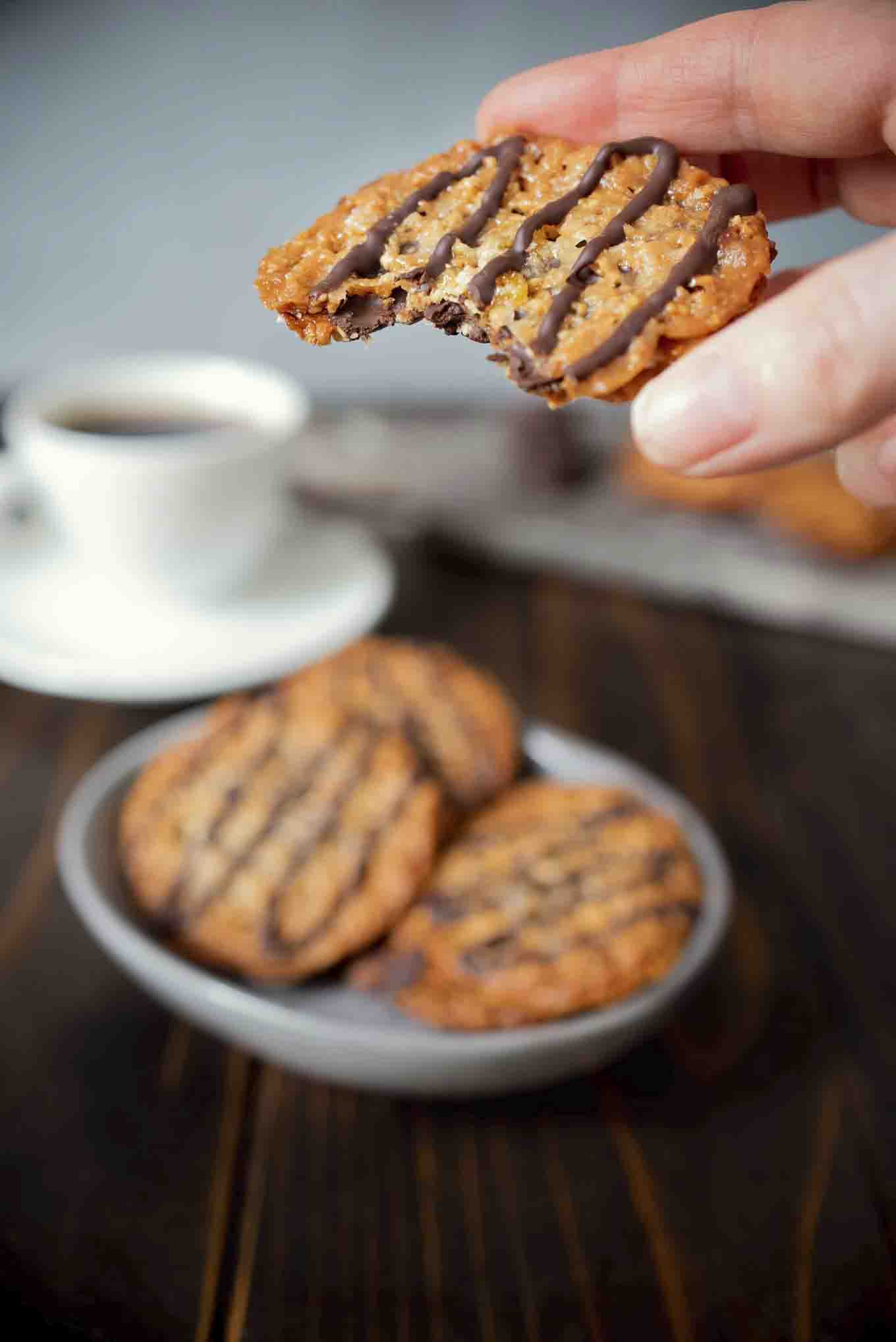 Holding a Florentine cookie with a bite taken out
