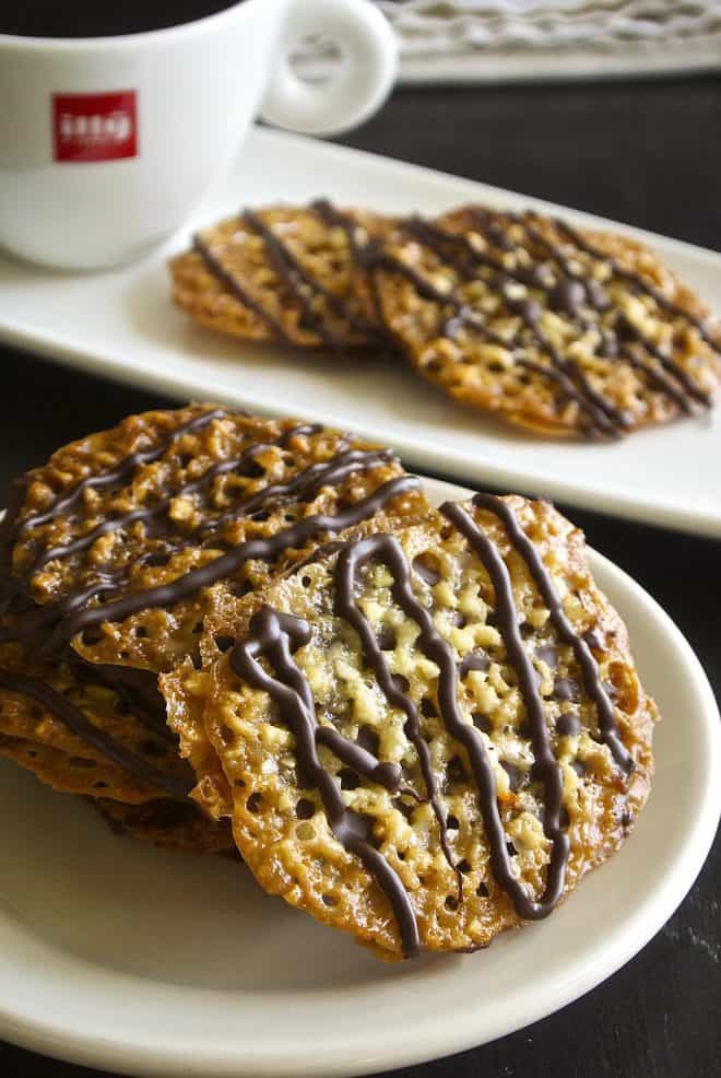 A stack of Florentine cookies on a white plate