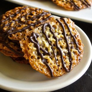 Florentine cookies are lace cookies made from  chopped almonds with orange & vanilla. They are then sandwiched with chocolate and you get the most delicious cookies.