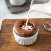 Pouring vanilla sauce into the center of the soufflé