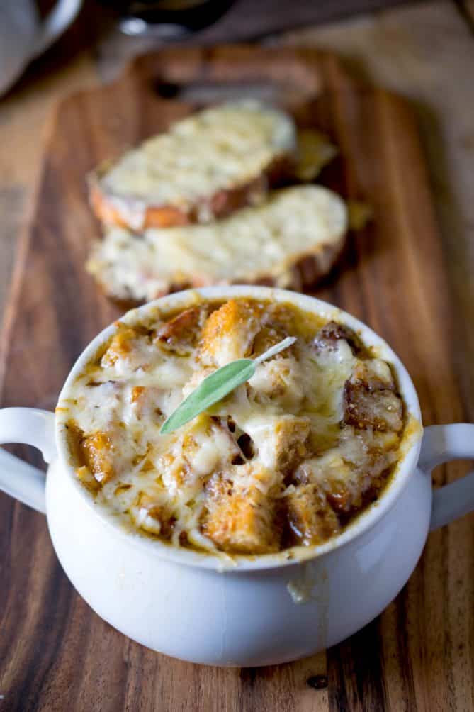 Melted cheese and a sage leave over crispy croutons on French onion soup