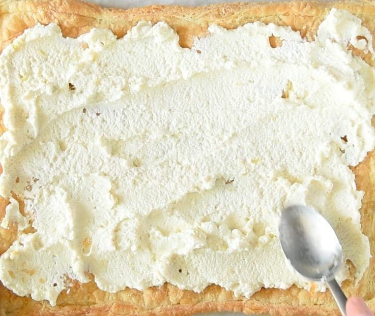 Ricotta mix is spread onto the baked puff pastry
