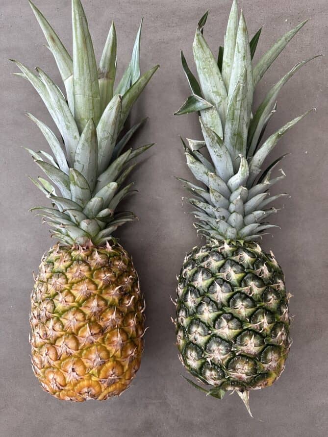 2 whole pineapples, 1 yellow and ripe, 1 green