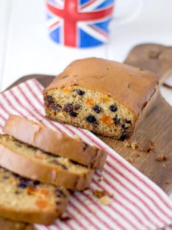 A tea cake cut showing the dried fruit inside