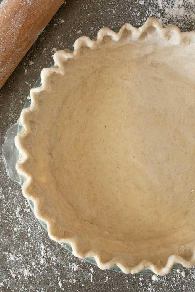 A closeup of gluten free pie crust showing the pretty fluted edge
