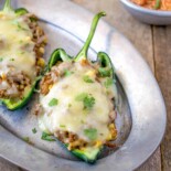 A green poblano pepper filled with ground beef and melted white cheese