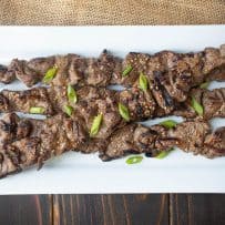 Grill marks adorn skewered pieces of beef