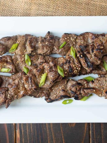 Grill marks adorn skewered pieces of beef