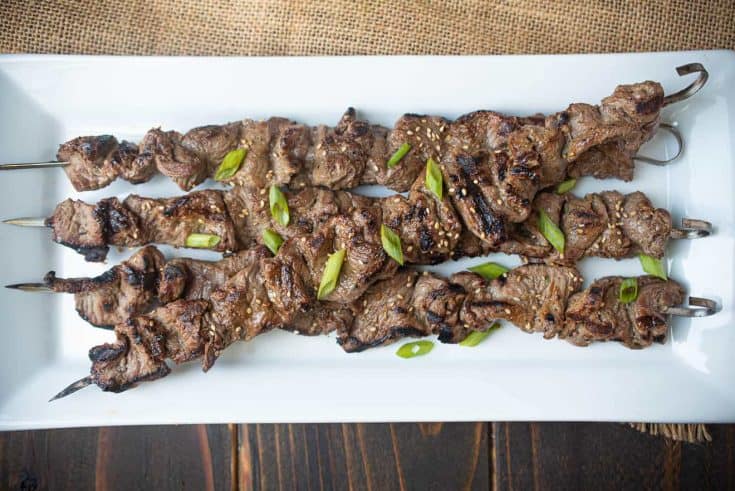 Grill marks adorn skewered pieces of beef