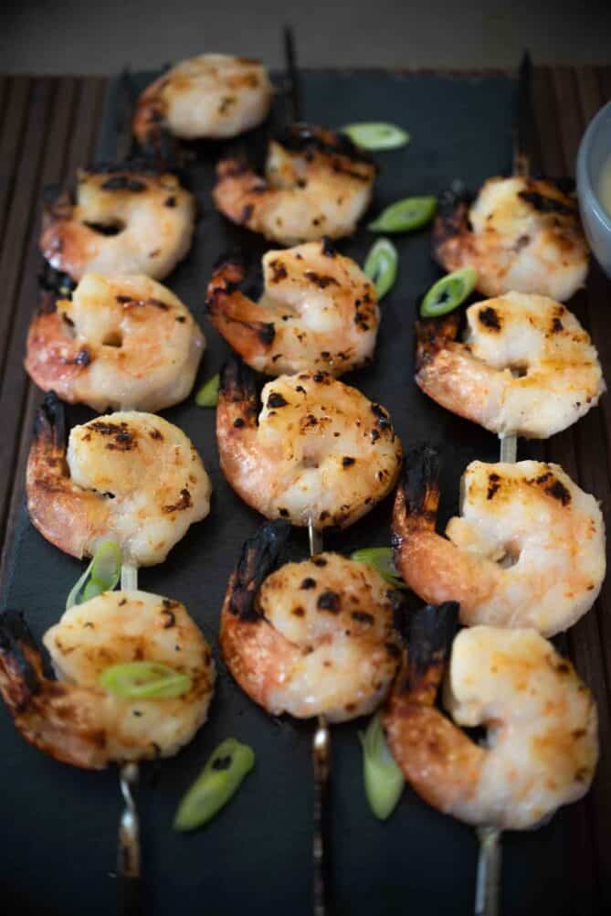 Shrimp kabob style on a slate serving plate