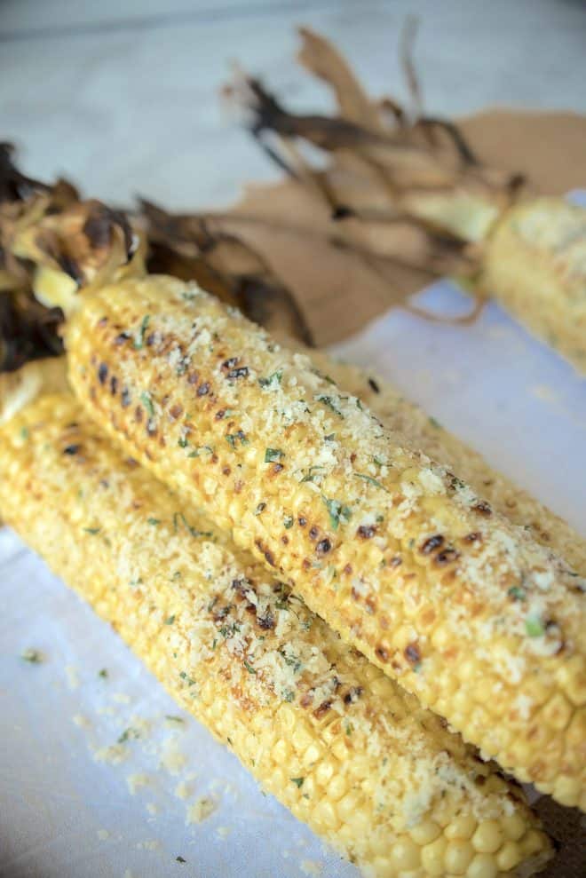 A closeup showing the grated Parmesan and basil coated corn
