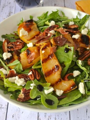 Pear and Crispy Prosciutto Salad ub a white bowl