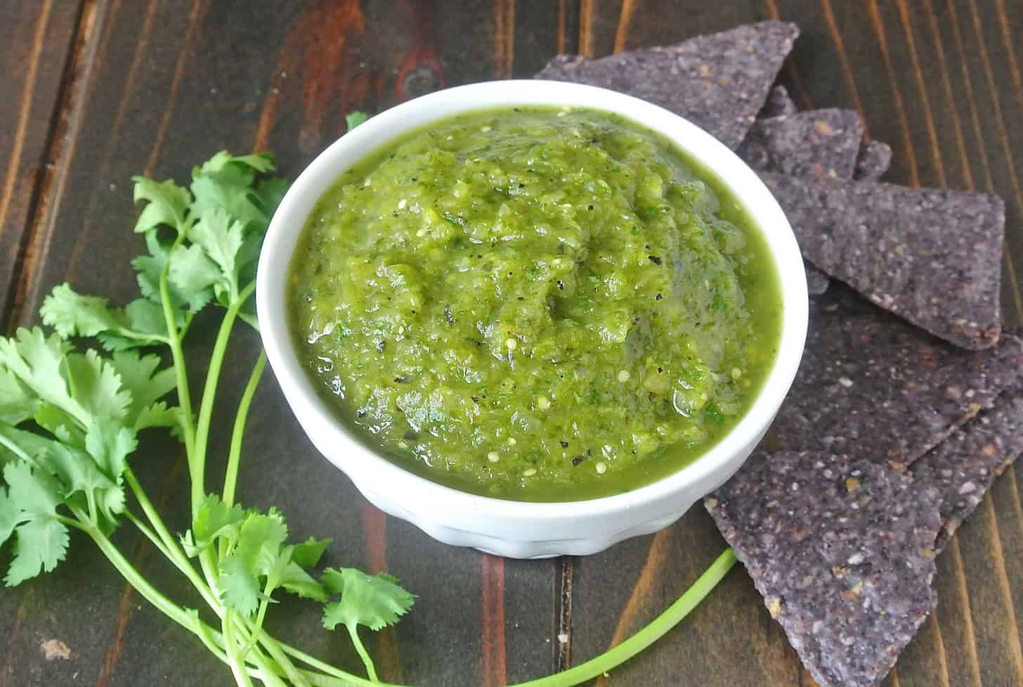 Vibrant green tomatillo salsa in a white bowl