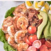 Grilled shrimp, tomatoes, avocado and bacon in a salad