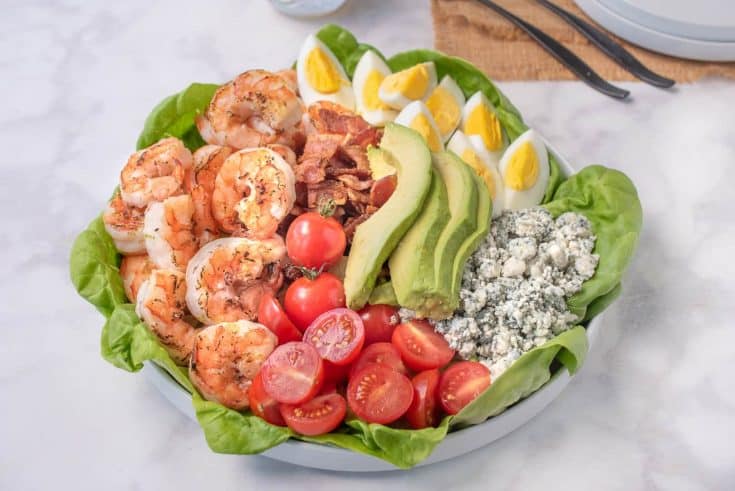 Grilled shrimp, tomato, bacon, avocado, egg and blue cheese on top of lettuce make up this grilled shrimp cobb salad