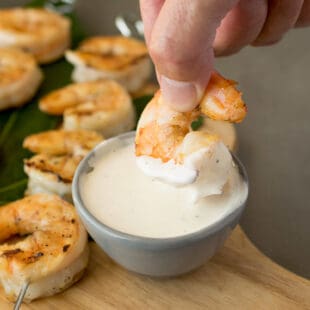 Dipping a grilled shrimp in sauce