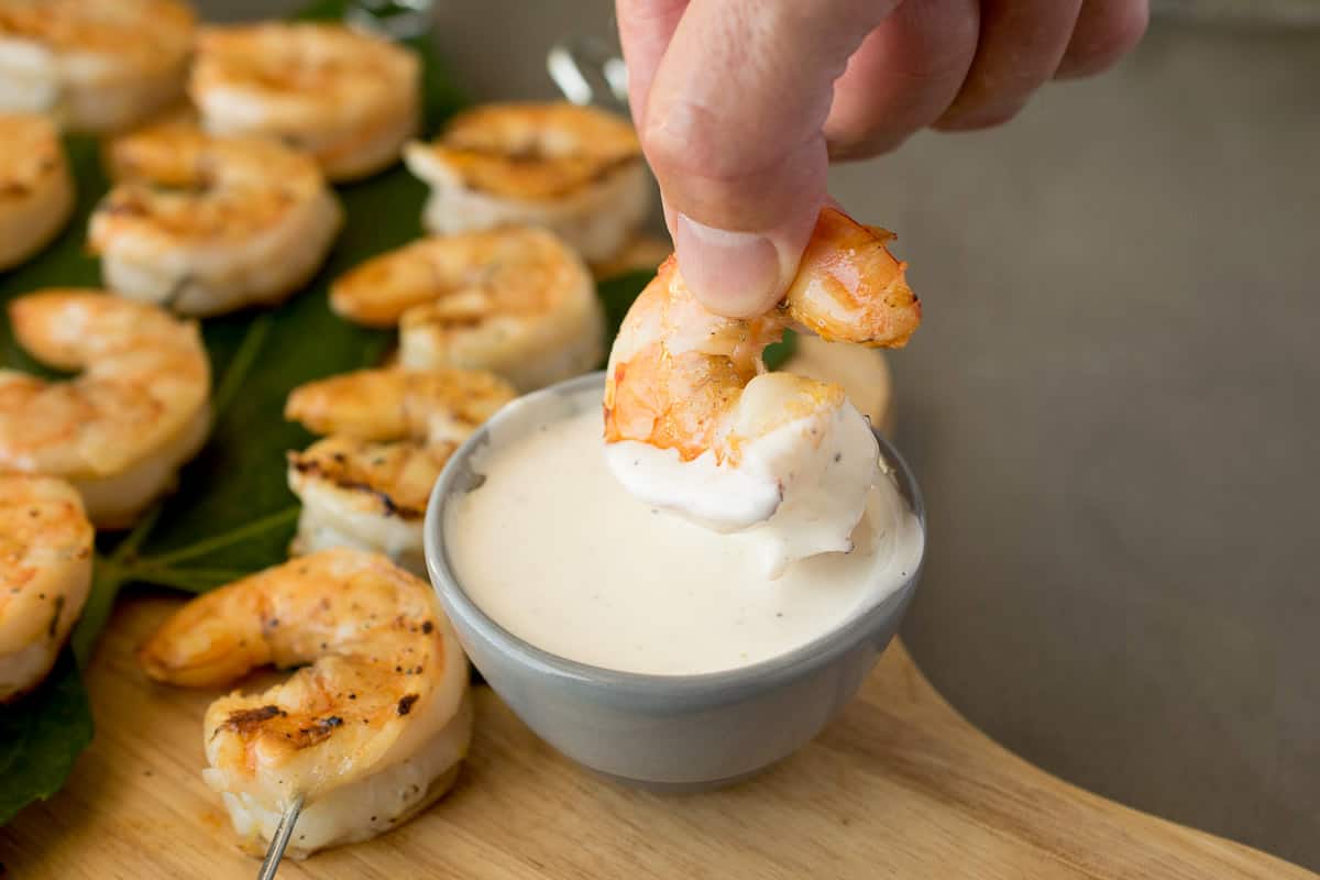 Dipping a grilled shrimp in sauce