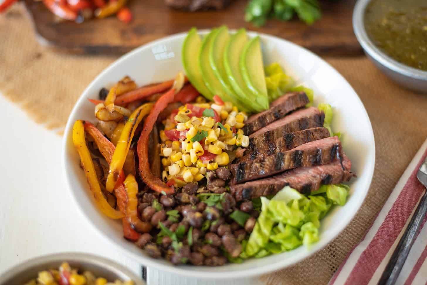 Grilled Sliced ​​Steak with Peppers, Corn Salsa and Beans