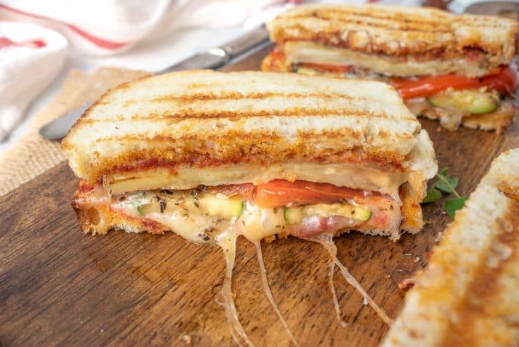 Grilled eggplant, zucchini bell pepper and cheese oozing from the panini