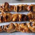 A closeup of charred and grilled chicken pieces
