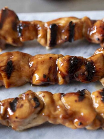 A closeup of charred and grilled chicken pieces