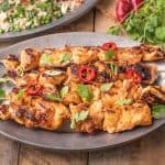 A grey serving platter with Grilled Thai Chicken Kabob Skewers