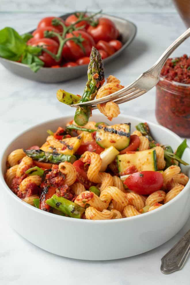 A forkful of pasta and grilled vegetables
