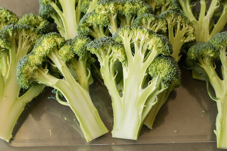 Stalks of raw broccoli ready to be grilled