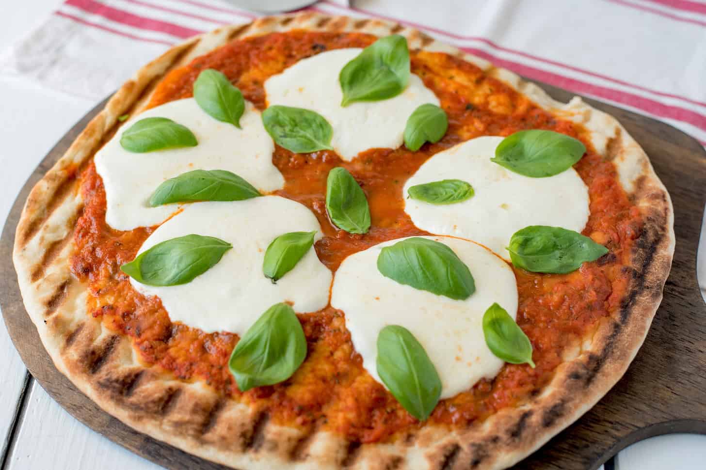 Fresh basil leaves on a grilled pizza