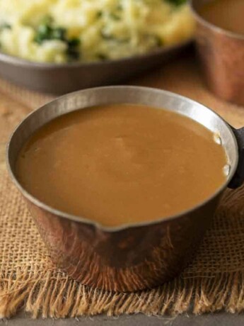 A small copper pot filled with gravy
