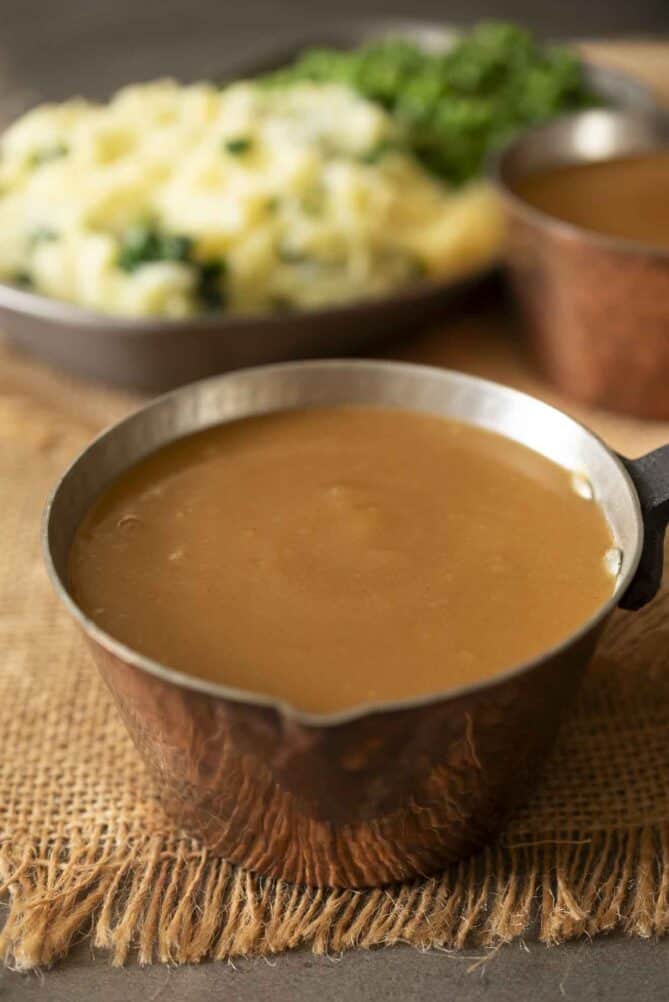 Brown gravy in a dish with mashed potato