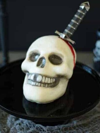 This Halloween skull and dagger cake is a fun and spooky centerpiece that will be sure to scare any Halloween partygoers. This cake can also serve as desserts for  your guests, if they dare to eat it.