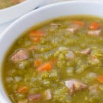 Large chunks of cooked ham in a split pea soup