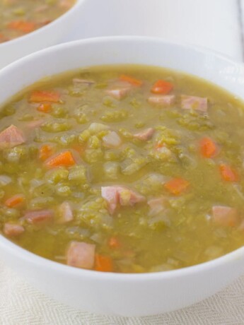 The soup with pieces of ham and carrot