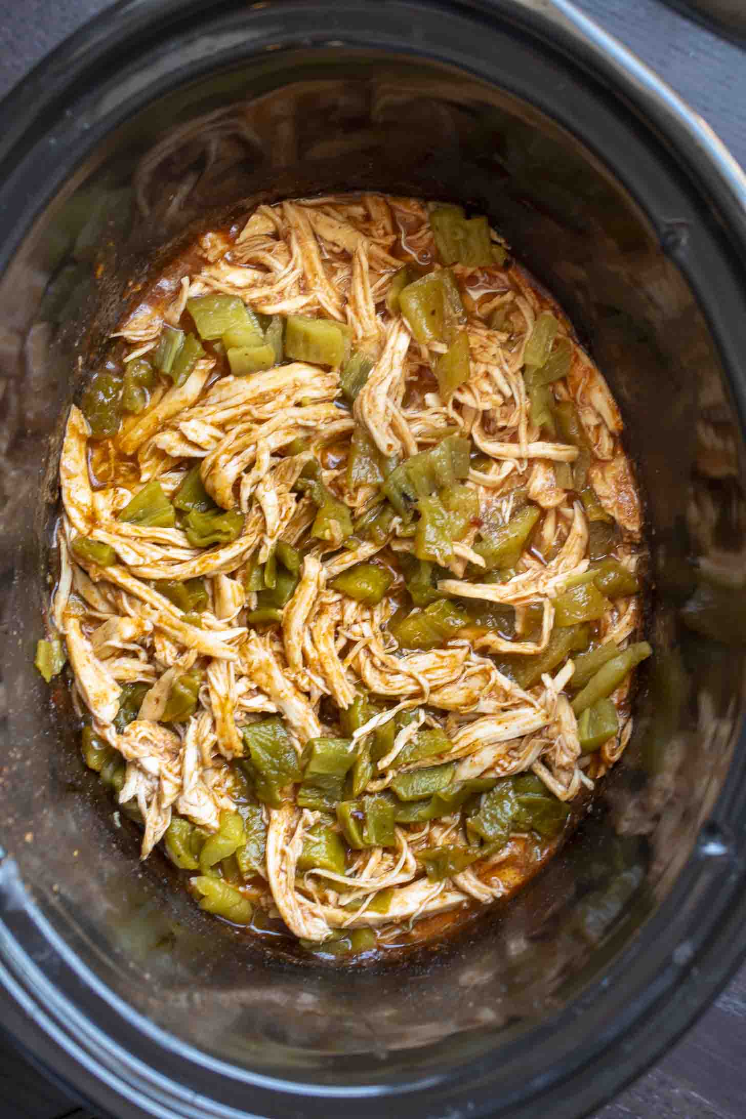 Shredded chicken and green chiles in a slow cooker