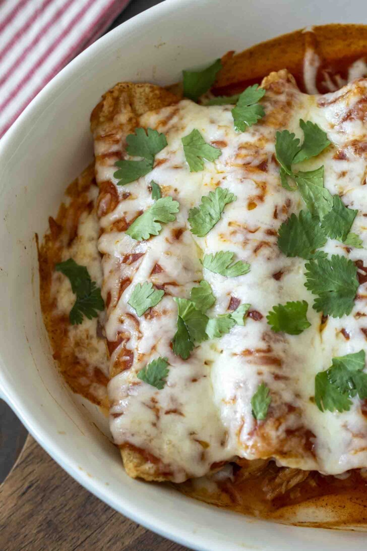 A closeup of cheese melted over baked enchiladas