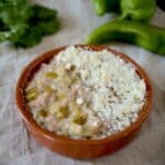 Refried beans mixed with hatch Chile peppers topped with crumbled cheese