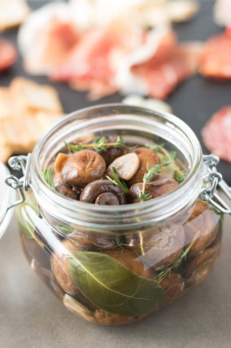 Herb and garlic marinated mushrooms in a sealable jar