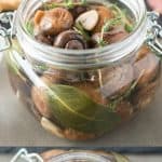 Herb and garlic marinated mushrooms bring something different to a charcuterie board. Mushrooms are cooked with thyme, rosemary, garlic and lemon, then jarred and allowed to marinate to intensify the flavors.