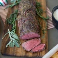 Perfectly roasted beef tenderloin garnished with fresh herbs